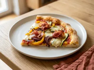Homemade roasted veggie, mozzarella and prosciutto pizza